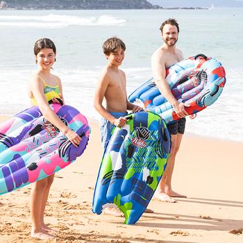 Family at the beach all holding the Wahu Wave Tube inflatable bodyboard