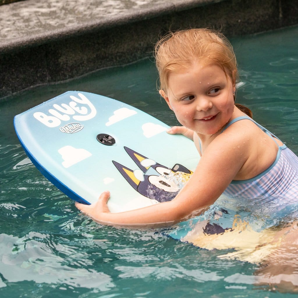 Child in pool using the Wahu x Bluey Body Board