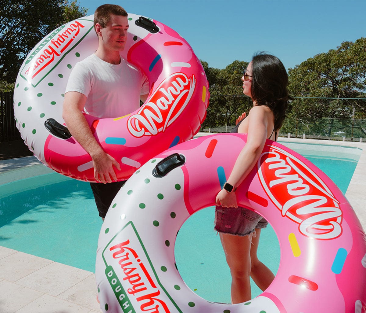 Wahu Big Dough x Krispy Kreme held by a man and woman by the pool