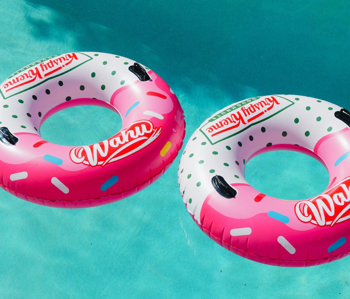 two floating Wahu Big Dough x Krispy Kreme inflatables in swimming pool