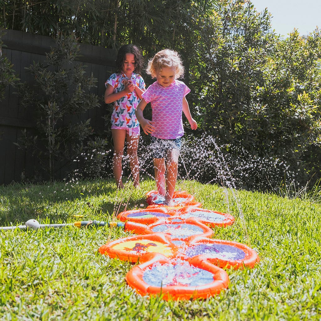 Girls playing Spidey &amp; Friends Hop Skip And Splash in backyard