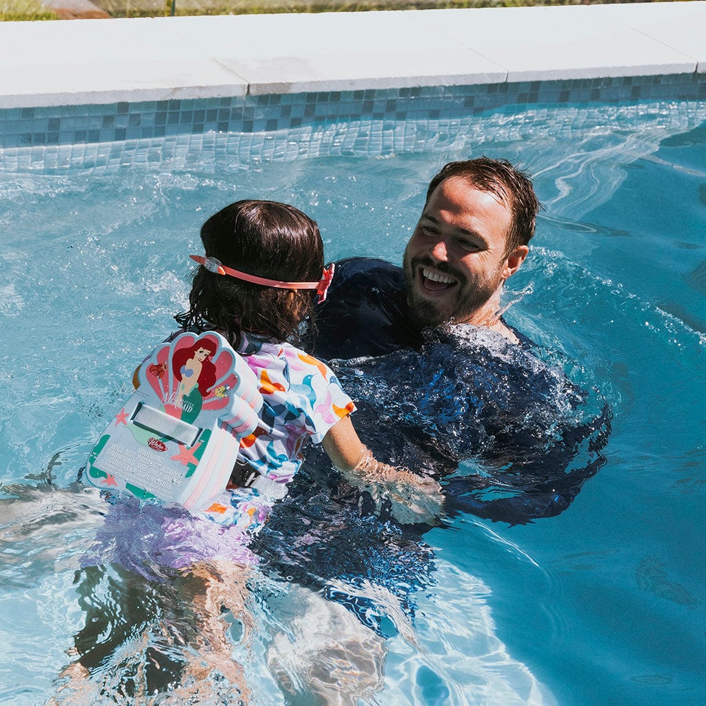 Father and daughter swimming in pool with Wahu The Little Mermaid Back Bubble