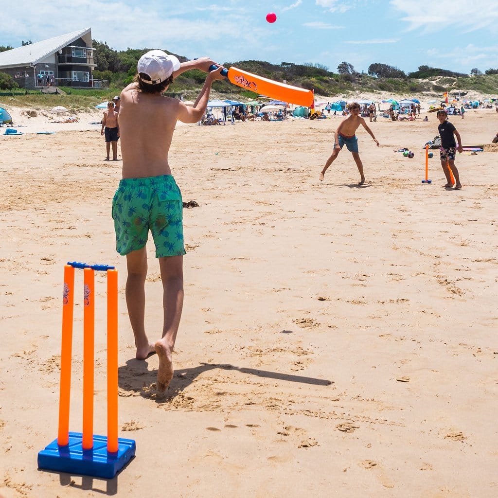Children at beach playing with the Wahu Double Cricket Set