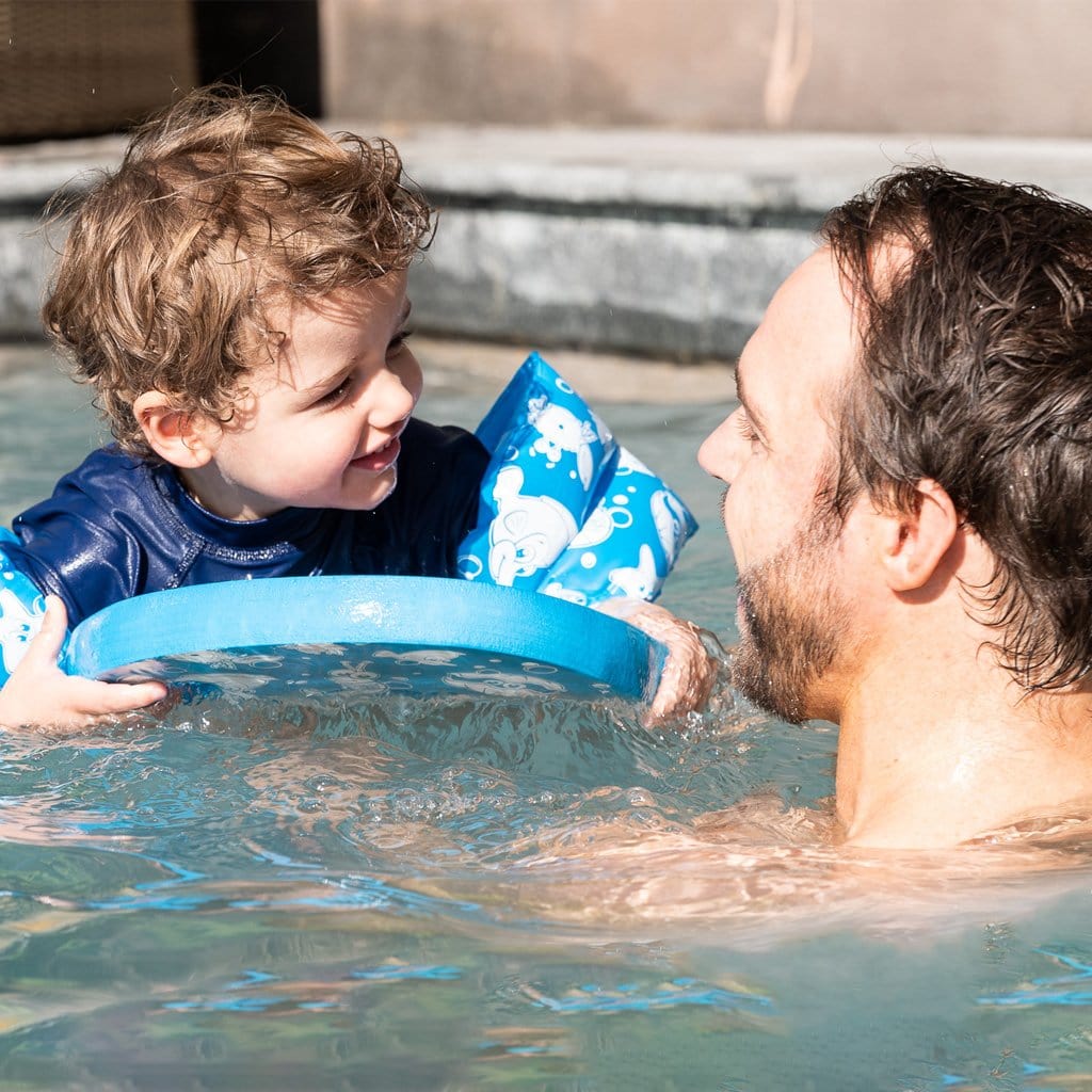 Family in pool with child using the Wahu Junior Kickboard