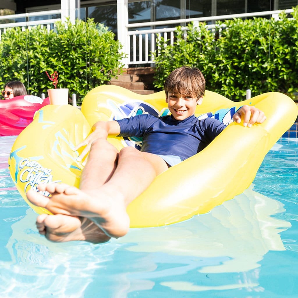 Child in pool relaxing on the Wahu Chillax Chair