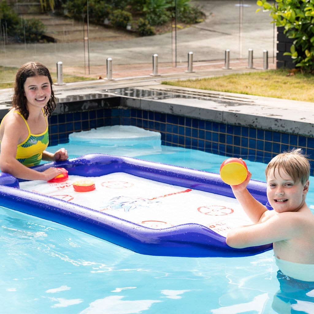 Children in the pool playing with the Wahu Aqua Hockey