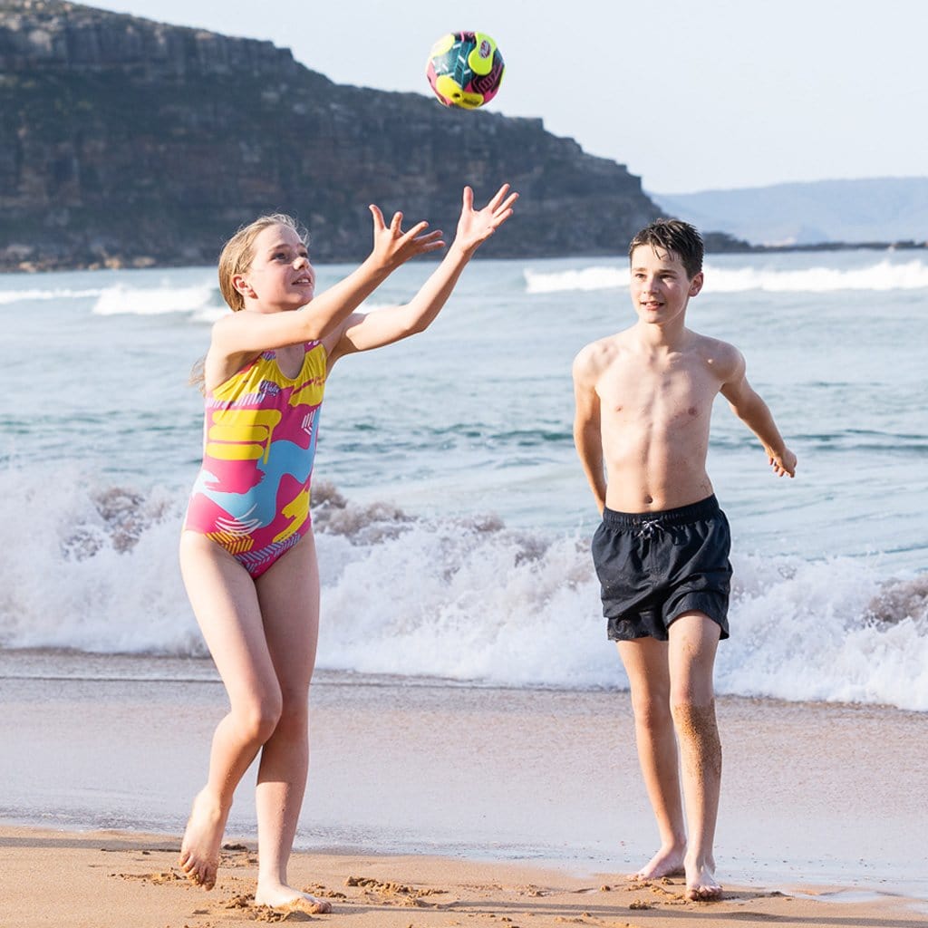 Children at beach playing with the Wahu Mini Soccer