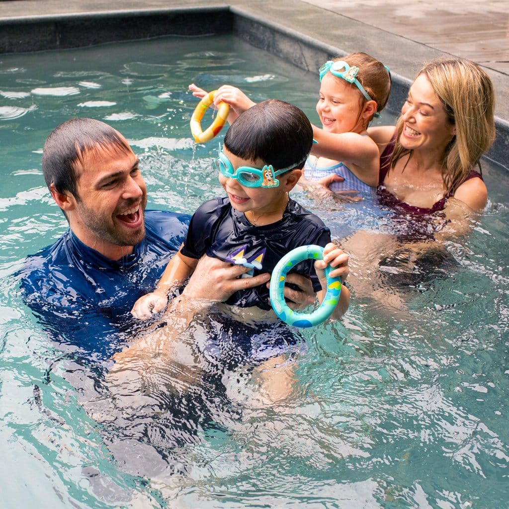 Family in pool playing with Bluey Dive Fun Pack