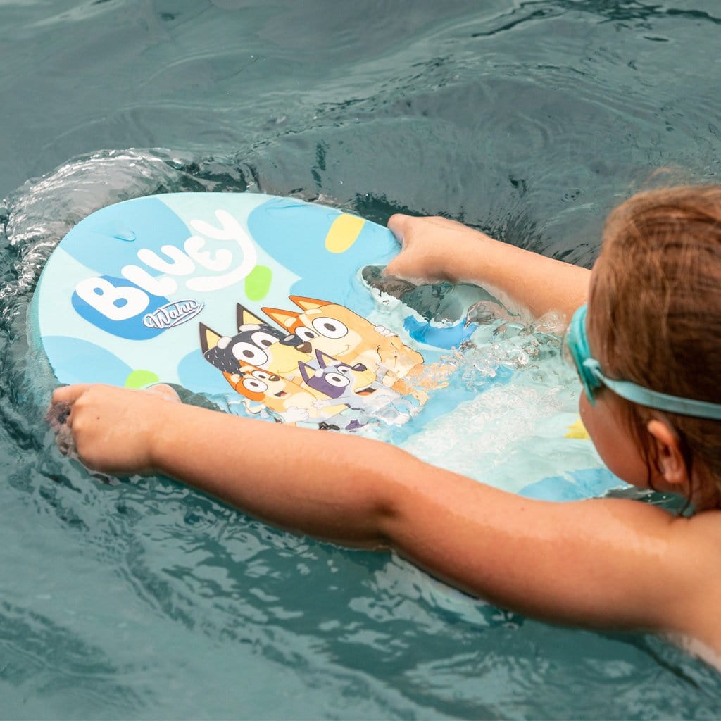 Child in pool using the Wahu x Bluey Kick Board