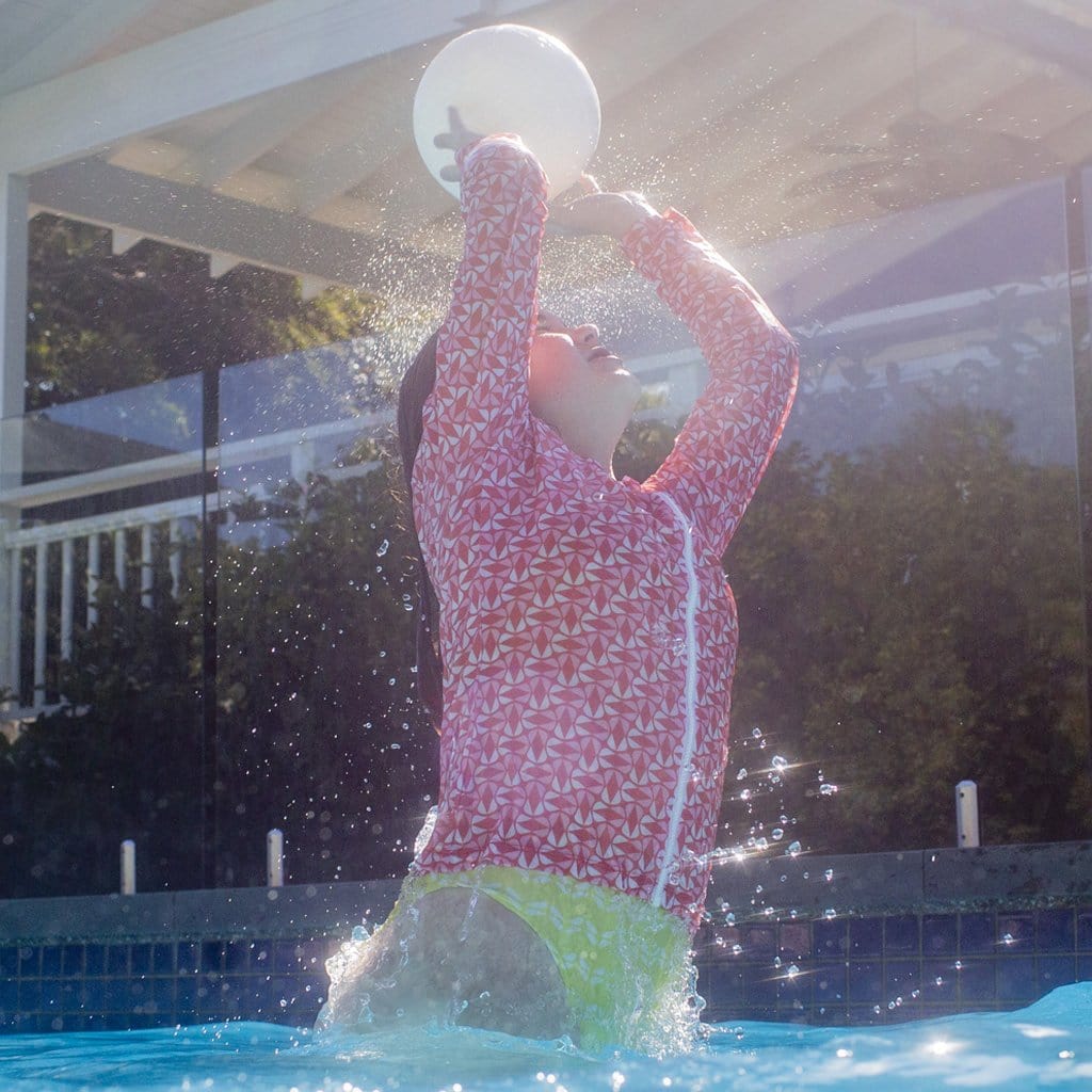 Child in pool playing with the Wahu 3 in One Game Pack