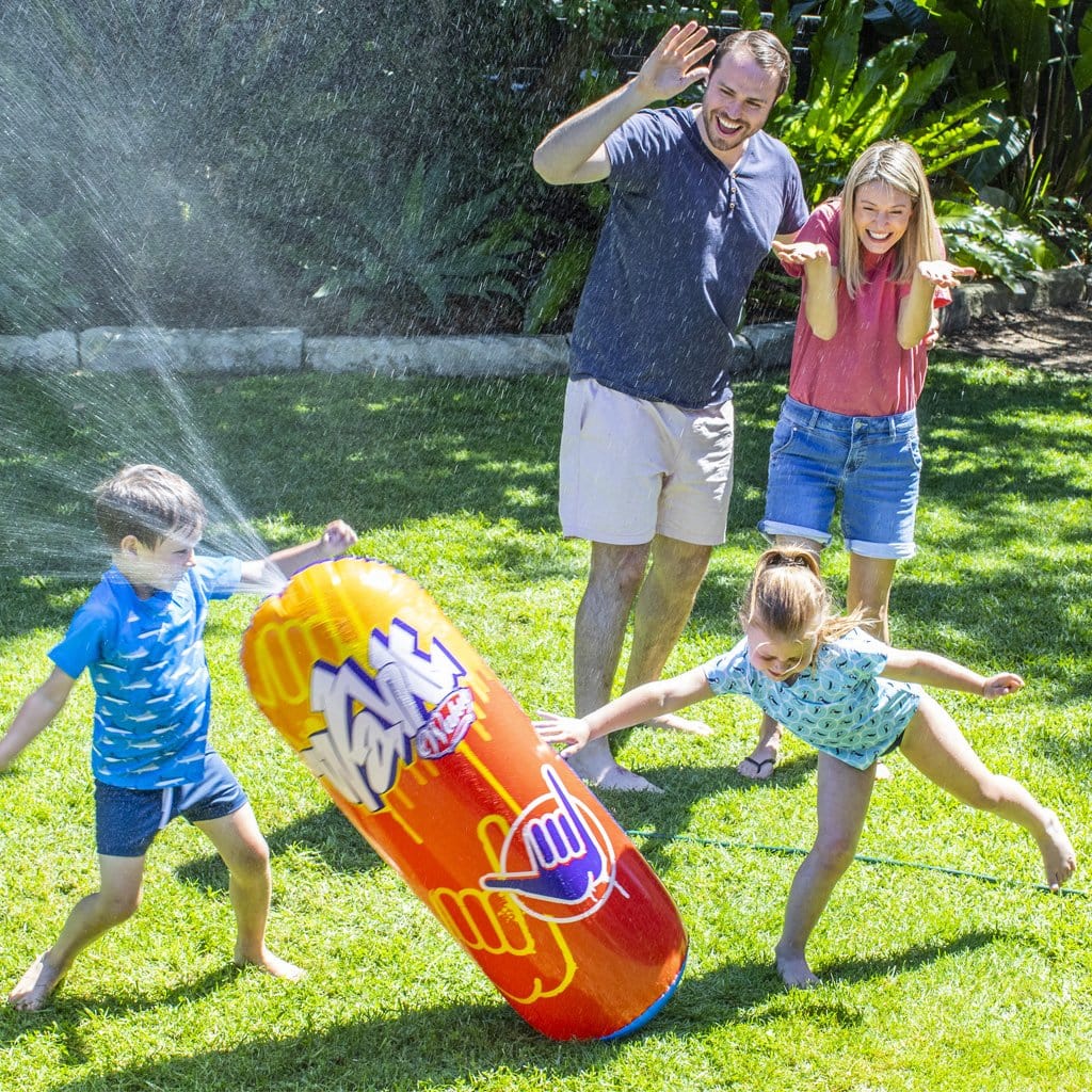 Family in backyard playing with the Wahu Bash &#39;N Splash