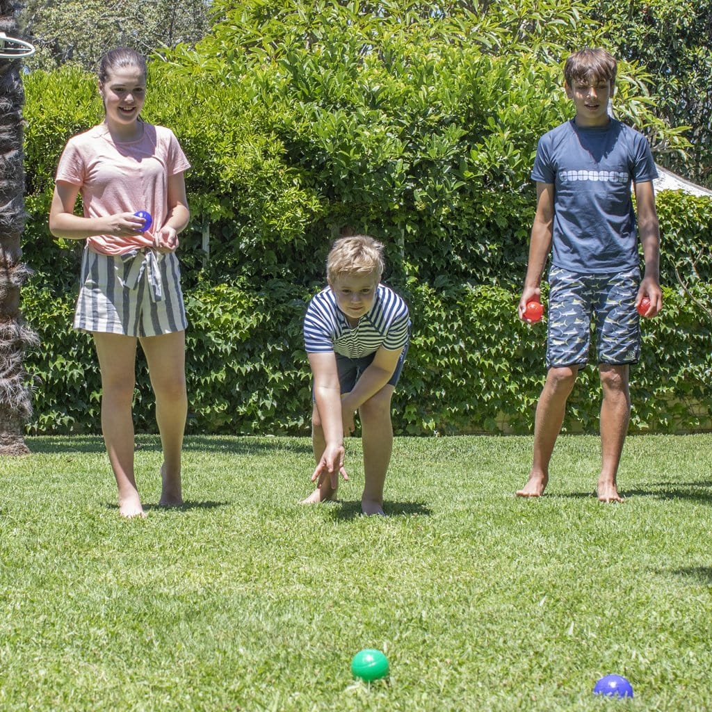 Children in backyard playing with the Bocce Set