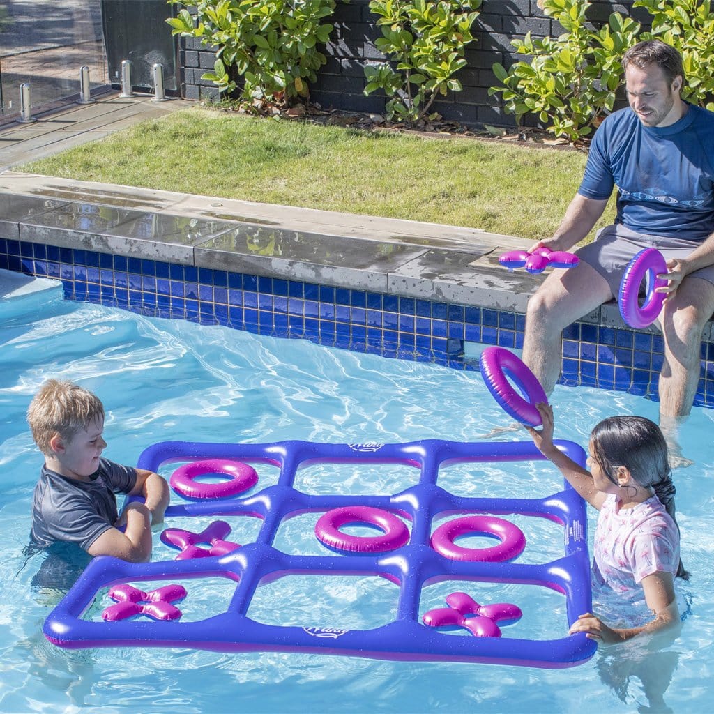 Family in pool playing with the Wahu Noughts &#39;N Crosses