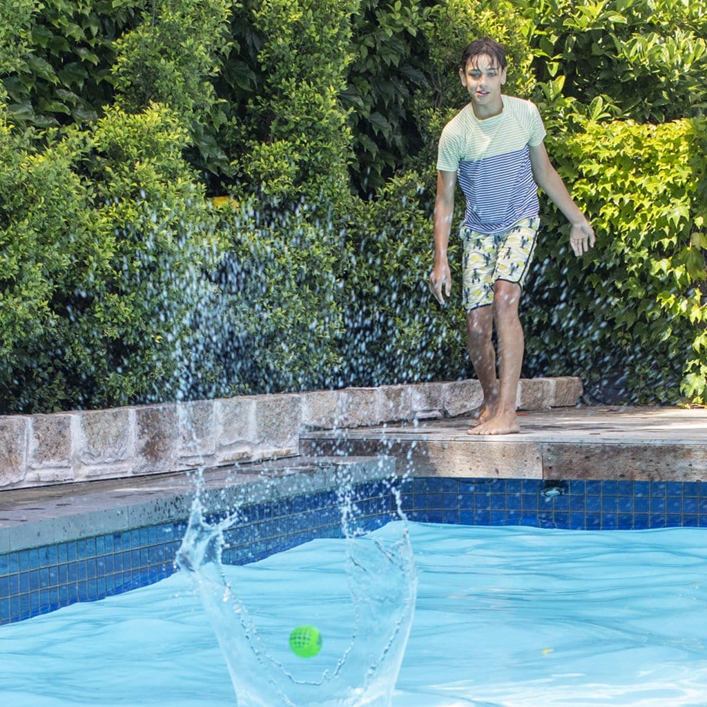 Child playing with the Wahu Super Grip Skimball Twin Pack 6cm at pool