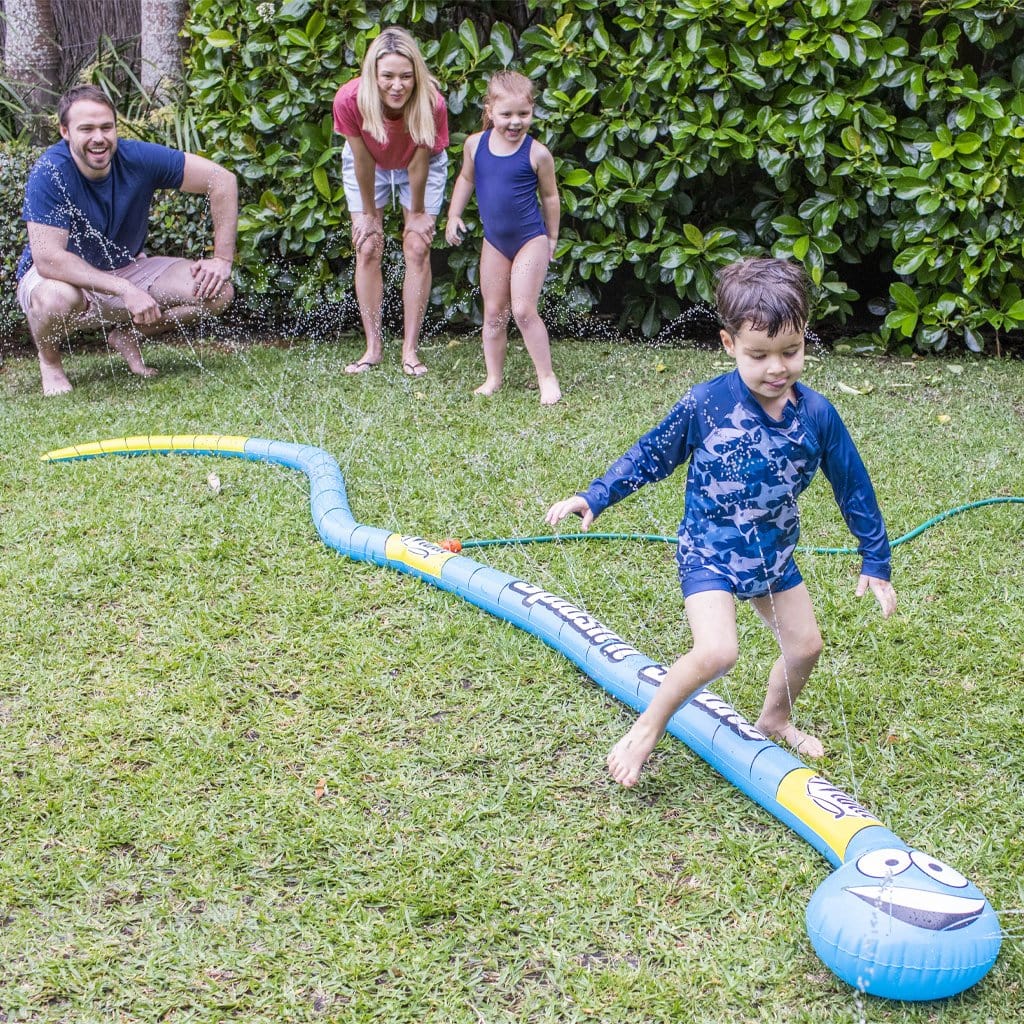 Family in backyard playing with the Wahu Splash &#39;N Snake
